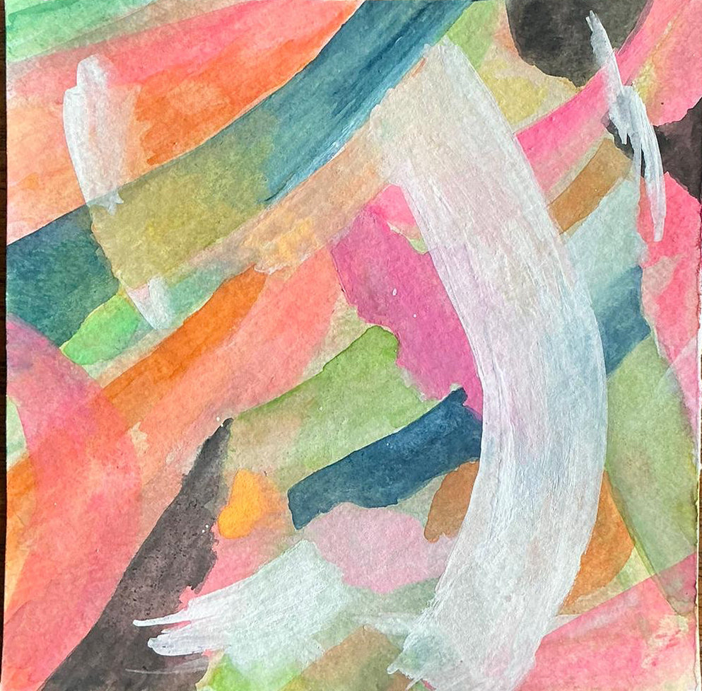 Abstract watercolor painting with multicolored brush strokes on a wooden surface