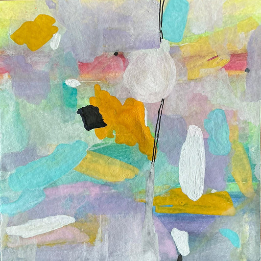 Abstract art piece with colorful shapes on a wooden surface