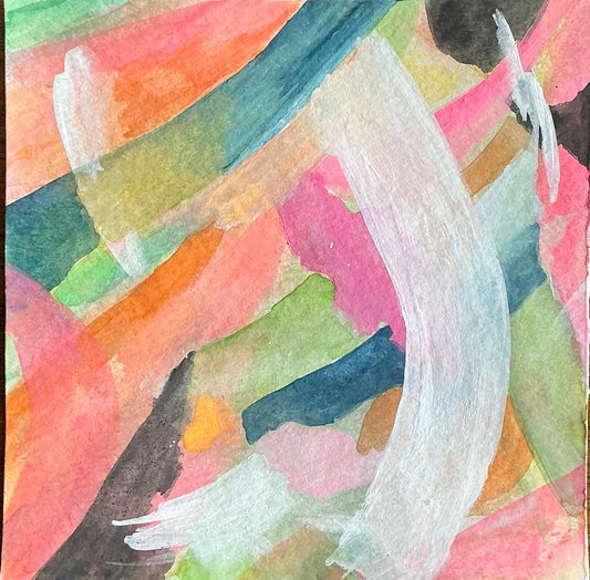 Abstract watercolor painting with multicolored brush strokes on a wooden surface